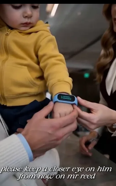 "Please keep a closer eye on him from now on, Mr. Reed" — the smart-band moment: Noah steadies his son's wrist so the band can be read (ep3, subtitles as aired)