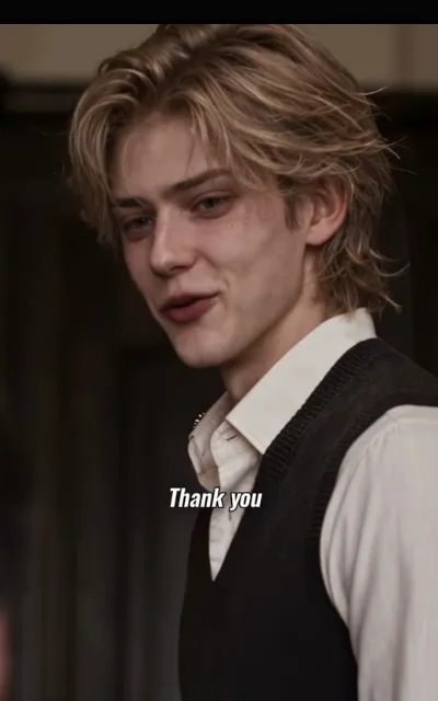The soft thanks — a light-blond man with loose curls and faint freckles in a cream collar shirt under a black knit vest, a relaxed half-smile, gaze lowered, the caption Thank you beneath (ep4; subtitles as aired — avatar source frame, avatar_theo crop (50,10,350,610))
