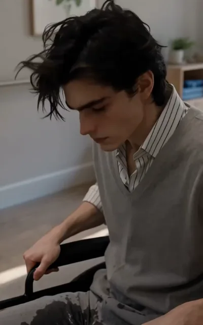 Adrian looks down at himself in the wheelchair, devastated by what his body can no longer do