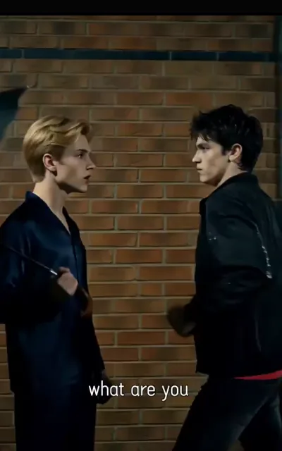 The standoff — two silhouettes in a parking structure at night, one holding a knife low, faces turned away from the lens, the caption reading only “what are you” (ep1; subtitles as aired; truncated caption as aired, no completion supplied; violence-context frame as aired, not amplified — the blade stays a story-level threat, nothing staged in progress)
