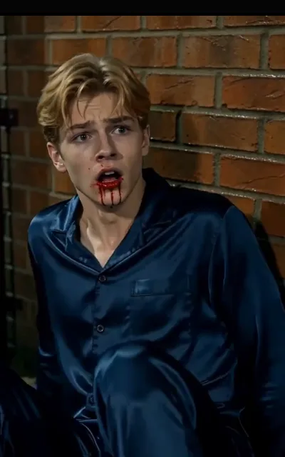 The aftermath — the navy-shirt striker on the turf under the floodlights, a thin red mark at the corner of his mouth, eyes still up (ep1; atmosphere beat; violence-context frame as aired, not amplified — aftermath wear only, described without the word)