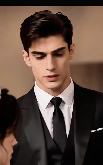The lowered gaze — the groom in black formalwear looking down, expression unreadable, a dark-haired figure small at the frame's edge (ep2; atmosphere beat; avatar source frame — avatar_dominic crop (0,40,300,640))