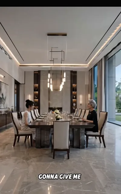 The long-table parley — a mansion dining room set for a formal meal, a bun-haired figure in cream at one end and a silver-haired matron in black at the other, a fragmentary caption “GONNA GIVE ME” beneath (ep4; atmosphere beat; partial on-screen caption as aired, no completion supplied — negotiation dialogue, no coercion on screen)