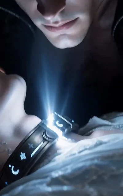 The star-and-moon collar, close-up — the mark Eli did not choose, cold light on silver (ep1)