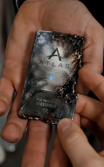 Frame ep03-f01 from episode 3 — The Atlas badge and the report (ep3; subtitles as aired — The report already answered you, Adrian. There's no reason to waste any more time on this.)