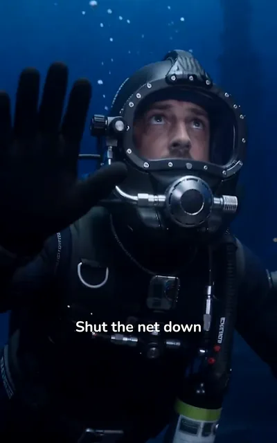 Frame ep01-f02 from episode 1 — Jordan in the dive helmet outside the net (ep1; subtitles as aired — Shut the net down. This was a live rescue, not a hunt.)