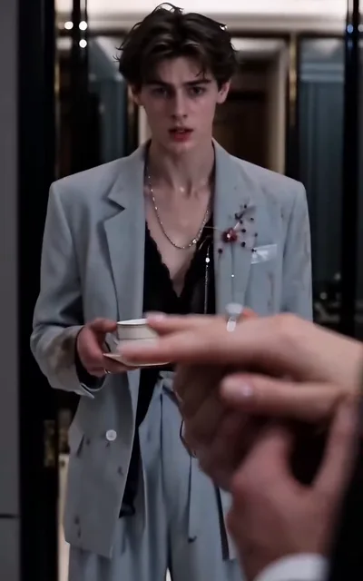 Frame ep04-f00 from episode 4 — Noel in the gray suit holding the ring (ep4; subtitles as aired — It hurts this much and you still want to take it?)