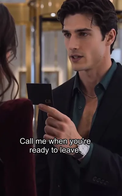 Frame ep01-f02 from episode 1 — The collector holding a card (ep1; subtitles as aired — Call me when you're ready to leave.)