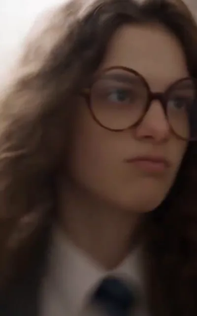 Frame ep02-f00 from episode 2 — Nina with the round glasses (ep2; subtitles as aired — She used to be too scared to lay a finger on me, like an obedient dog.)