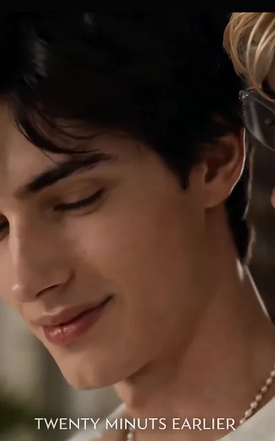 Kael with his eyes closed in a faint smile, Rhys just in frame, "TWENTY MINUTES EARLIER" stamped across the rewind — the flashback structure the finale leans on (ep5; intimate frame as aired, not amplified)