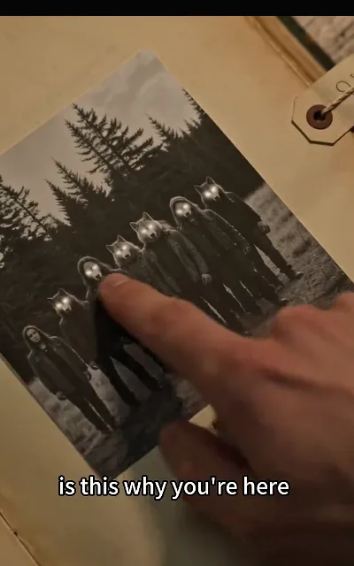A black-and-white photograph of a wolf-headed figure — the pack’s own record, staged as designed — above the question "is this why you're here" (ep3, subtitles as aired; eerie-design frame as aired, not amplified — low horror, station styling)
