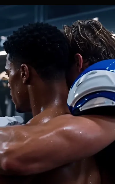 The locker room’s reigning presence in profile — short Afro-fade curls sweat-dark at the temple, pads and shoulders still carrying the game; also the source of his avatar (ep1)