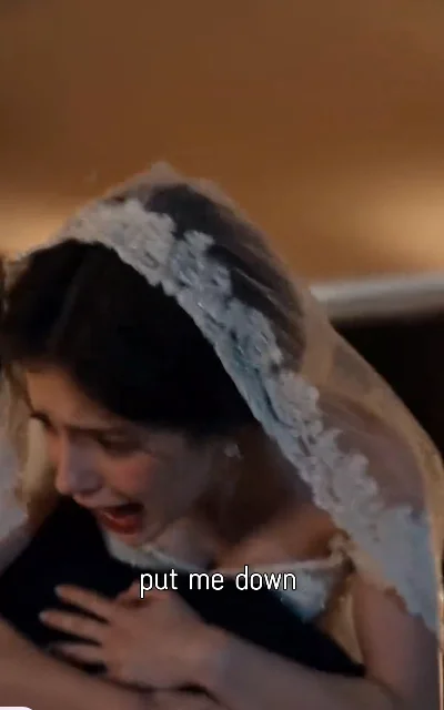 Episode 2 frame: Lily being carried, 'put me down' — wedding procession, DAKO not-amplified context