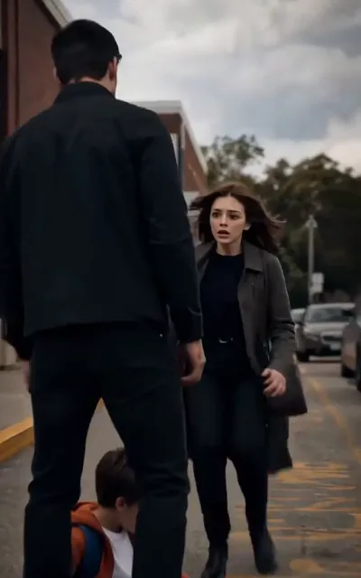 Emma frozen on the street — a man in glasses, a little one beside him, a face she never expected (ep3; the man stays unnamed, identity left to the story)