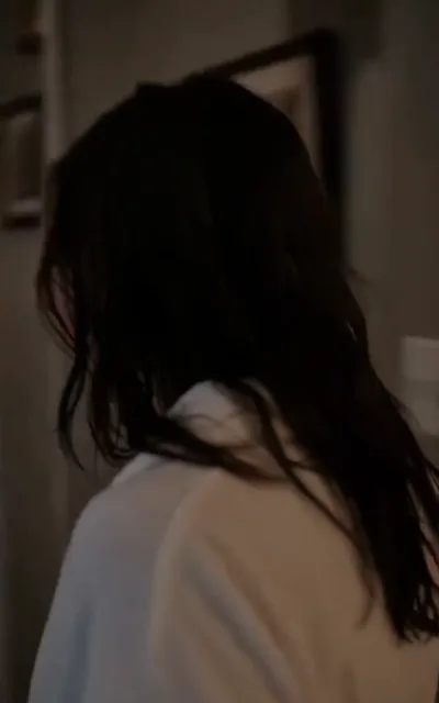 Backlit and out of focus — a long-haired silhouette, identity left to the story (ep5)