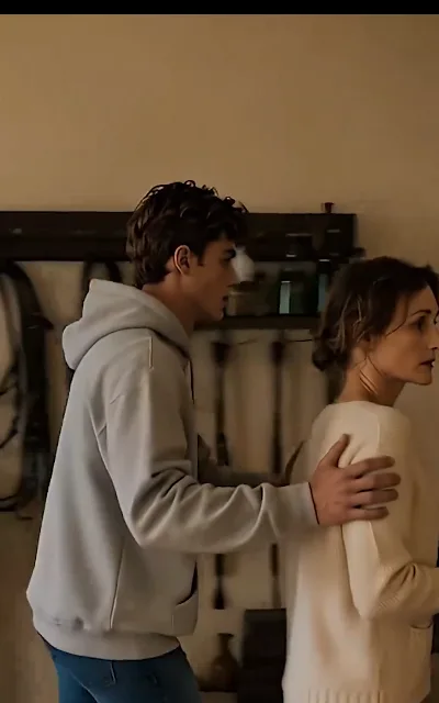 An arm around Maggie's shoulder, steering her gently away — a son carrying a worry he will not explain to the person it is about (ep5; as-aired family moment, no cause retold)