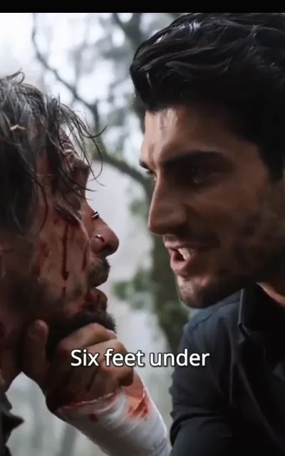The woods threat — a bandaged hand gripping a young woman's jaw in the mist between bare trunks, her eyes lifted, no contact beyond the grip — “Six feet under” (ep1; subtitles as aired; violence-context frame as aired, not amplified — coercion kept at story level, no violence in progress)