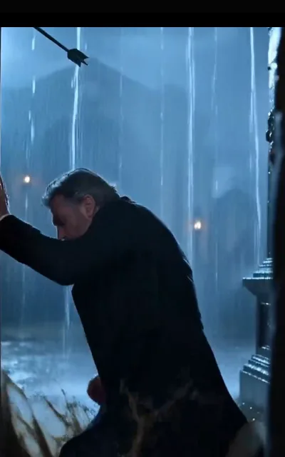 The rain ambush — a gray-haired older man drenched and hunched against cover in the downpour, a black crossbow bolt streaking toward him through the rain, no impact shown (ep2; violence-context frame as aired, not amplified — bolt in flight, conflict tension kept at line level)