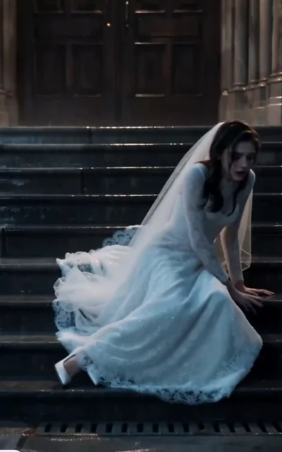 Episode 1 frame: Emily alone on rain-soaked steps in a wedding dress, the post-abandonment collapse — emotional atmosphere