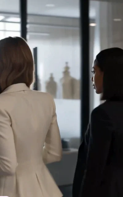 Episode 3 frame: Emily in a black business suit with red lipstick — the career-revenge visual transformation