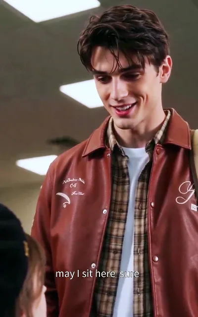 'May I sit here?' — an unnamed dark-haired newcomer settles in beside Zoe; who he is, the show isn't saying yet