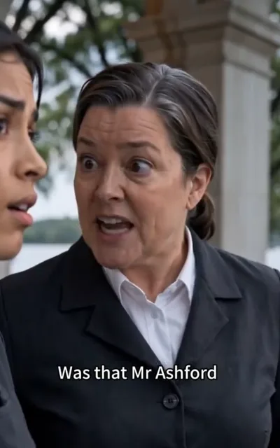 The name — a middle-aged woman in a black suit frozen mid-shock beside the half-turned profile of the young woman, the caption Was that Mr Ashford beneath (ep2; subtitles as aired — the male lead's surname evidence frame)