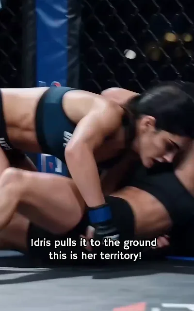 "Idris pulls it to the ground / this is her territory!" — the broadcast call as the fight hits the mat (ep1, subtitles as aired)