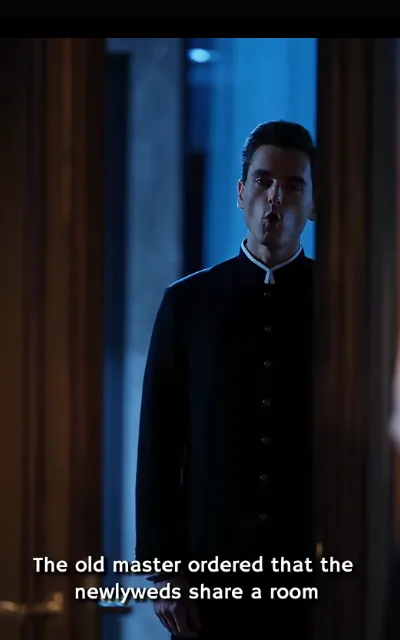 The butler in the doorway — black mandarin-collar uniform, white neckerchief, pursing an exaggerated kiss to mock the order — “The old master ordered that the newlyweds share a room” (ep3; subtitles as aired; unnamed staff, no avatar)