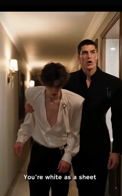 The corridor walk — Elias barely upright in ivory satin, Dante’s arm across his shoulders keeping him steady under the sconce light — “You’re white as a sheet” (ep5; subtitles as aired)