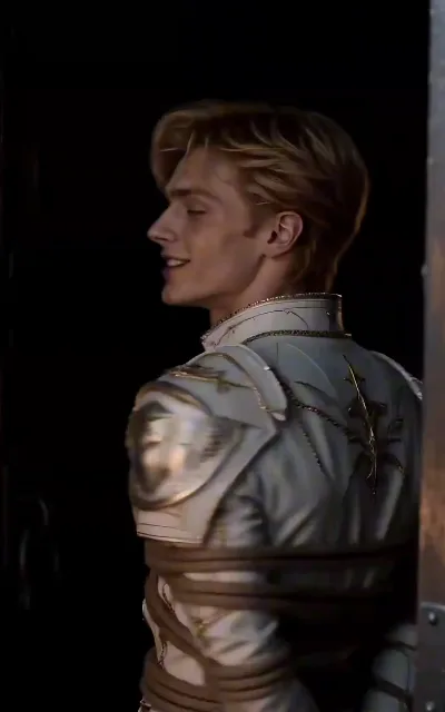 The captive knight — the captured prince in white-and-gold armor, bound in rope against the dark