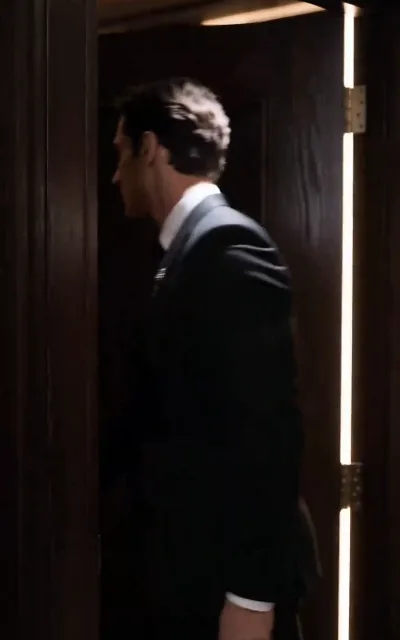 A door half-open, a blade of warm light — Ethan slips away from the noise