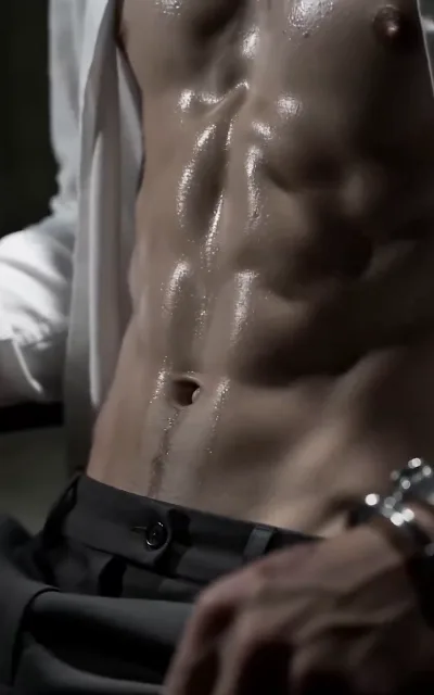 An open shirt and a water-beaded torso, ringed fingers splayed — skin exactly as the scene plays it, staged exactly as shot (ep1; shirtless frame as aired, no explicit content)