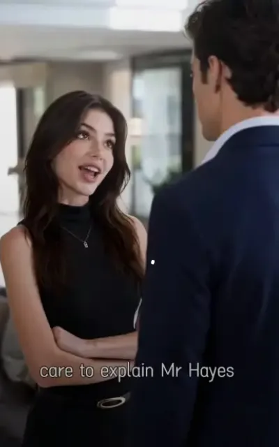 The confrontation — in a bright modern office, a woman with chestnut waves and freckles in a black sleeveless turtleneck, arms crossed, chin up in challenge toward a man in a navy suit seen from behind, the caption care to explain Mr Hayes beneath (ep3 content per reattribution — capture point beyond ep2's own runtime, in-frame episode-3 UI; subtitles as aired — Carter Hayes surname evidence)