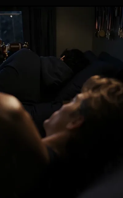 The shared room at night — one bed occupied, one head buried in a pillow, medals on the wall catching the dark (ep7; twin-beds anchor, atmosphere beat)