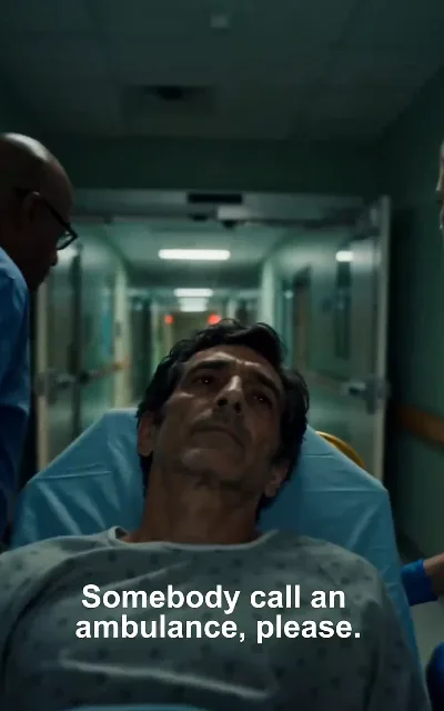 "Somebody call an ambulance, please." — a hospital gurney mid-transfer, a gray-gowned patient and the medics around him: the turn the story takes in the home stretch (ep4, subtitles as aired; as-aired wording, in-story emergency)